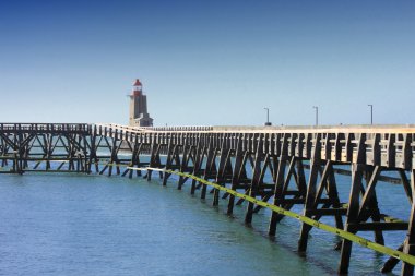 Wooden pier and lighthouse of the port of fécamps in normandy france