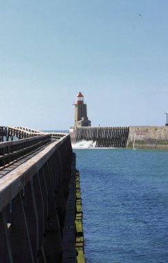 Wooden pier and lighthouse of the port of fécamps in normandy france