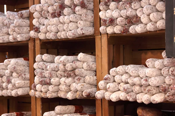 stock image Different varieties of sausage salami on a stall