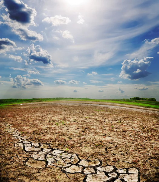 stock image Dramatic sky over dry cracked earth