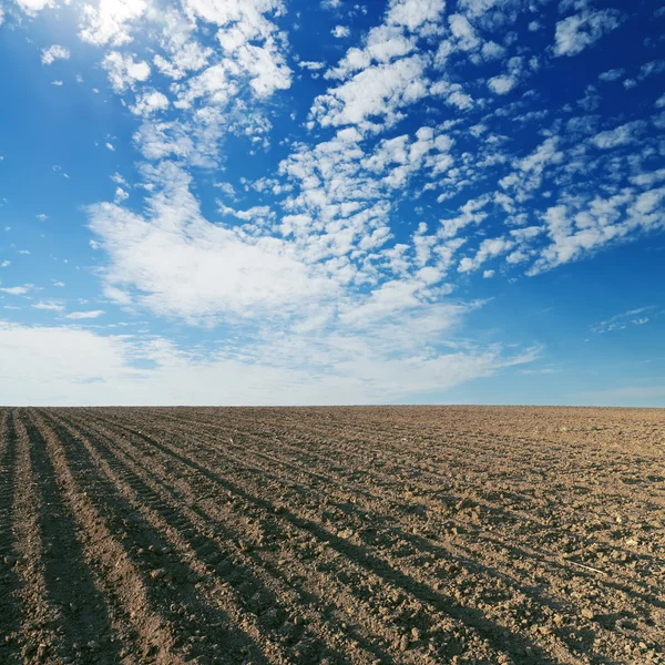 Чорне культивоване поле і блакитне небо — стокове фото