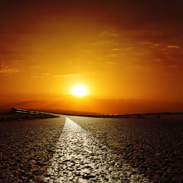 stock image Asphalt road to red sunset