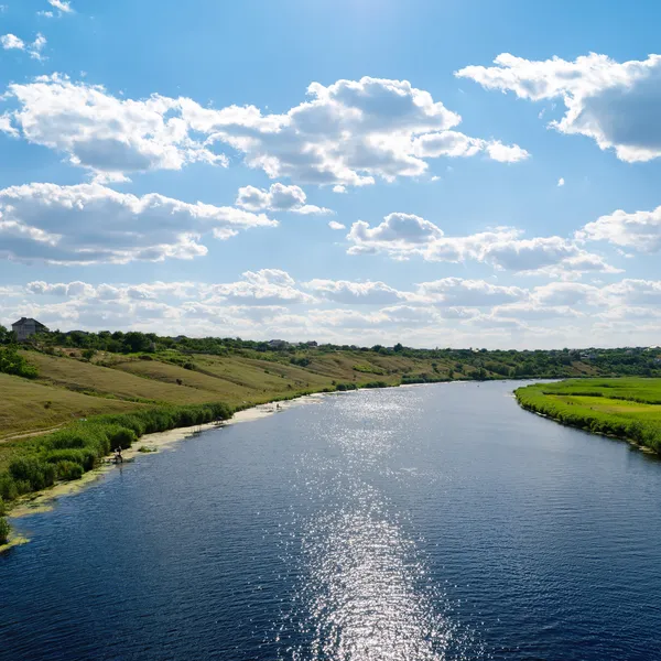 Vista sul fiume con riflessi e cielo azzurro nuvoloso — Foto Stock