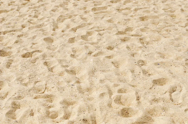 Песок на пляже в качестве фона — стоковое фото