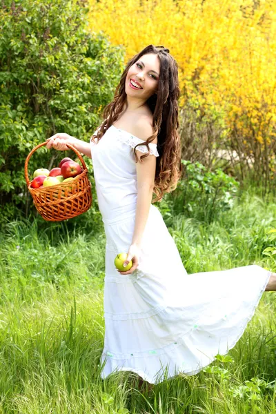 Portrait of happy smiling woman with basket running across field — Stockfoto
