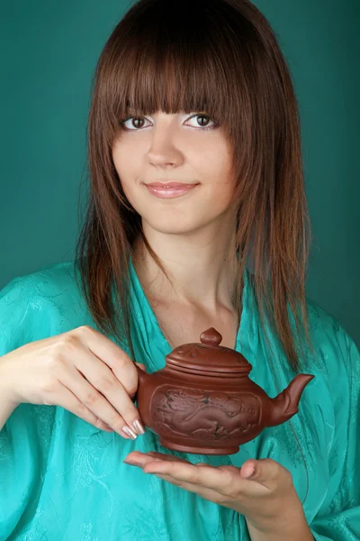 Tea ceremony with beautiful young woman on blue background — Stock Photo, Image