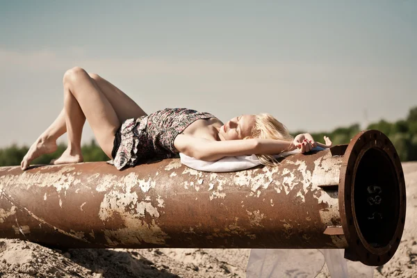Girl on rusty pipe — Stock Photo, Image