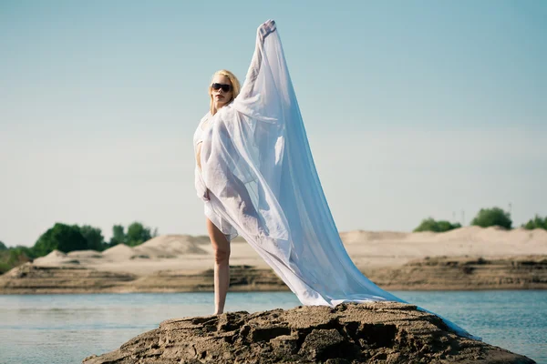 Woman with big white cloth — Stock Photo, Image