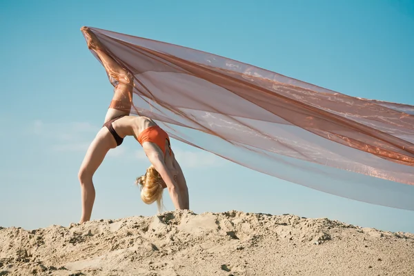 Girl dancing with big orange cloth — Stock Photo, Image