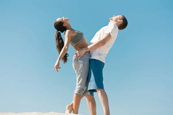 Sport couple on sand — Stock Photo, Image
