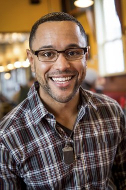 Portrait of Young Black Man in Coffee Shop clipart