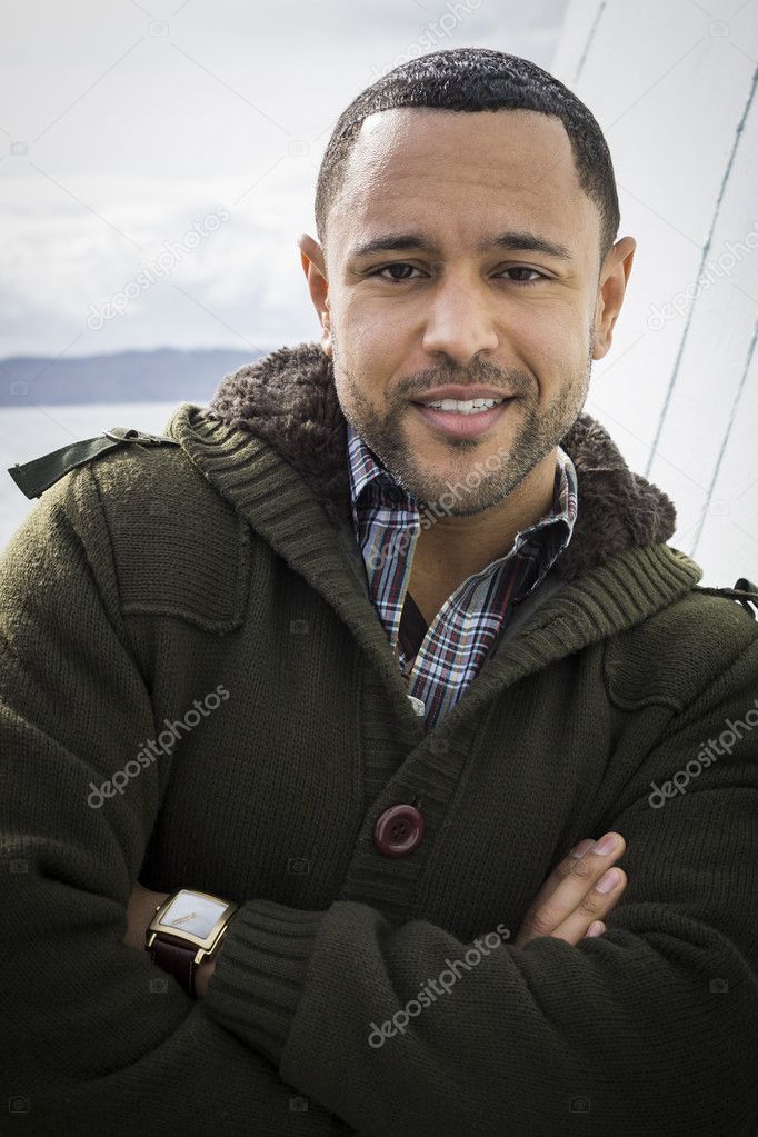 Young Black Man on Boat Deck with Arms Crossed