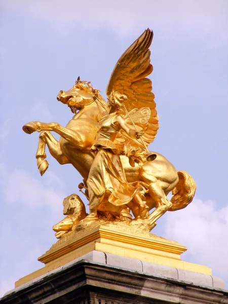 Golden sculpture of woman and horse — Stock Photo, Image