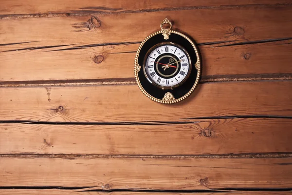 stock image On the wall of the old house of the old clock