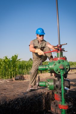 Oil worker check oil pump clipart