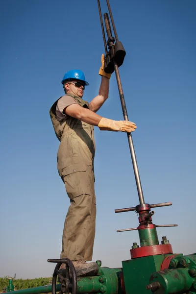 Olja worker kontrollera oljepumpen — Stockfoto