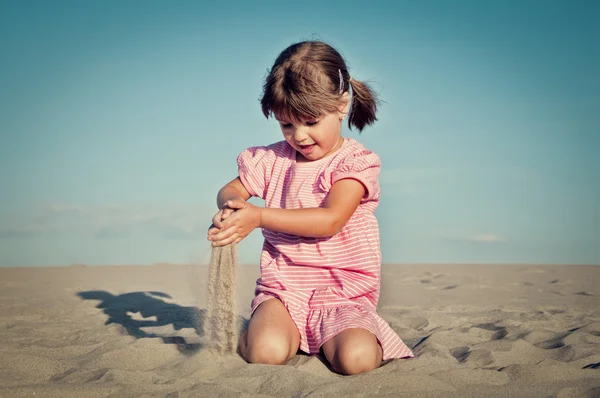 Kumlu bir plaj üzerinde sevimli küçük kız — Stok fotoğraf