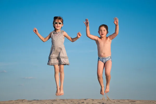 Urocza małej dziewczynki i chłopiec gra na plaży — Zdjęcie stockowe