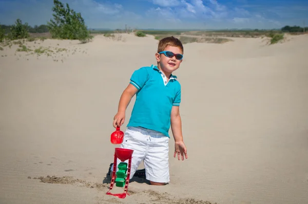 Entzückender kleiner Junge spielt am Sandstrand — Stockfoto