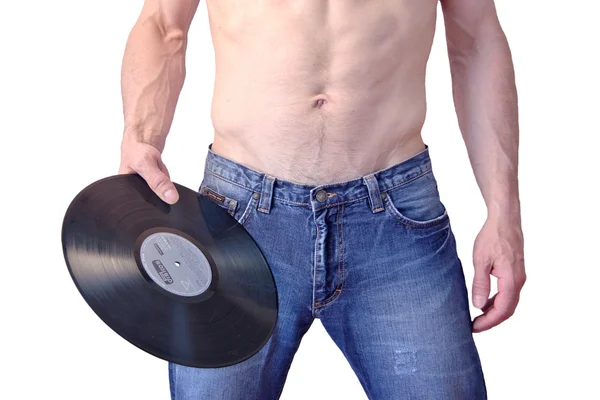 A man in jeans holding a phonograph record — Stock Photo, Image