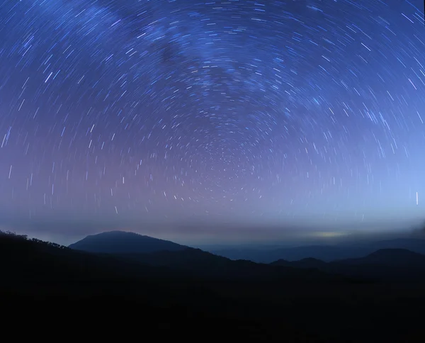 Star trails above high mountain — Stock Photo, Image