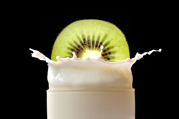 Splashing milk with kiwi — Stock Photo, Image