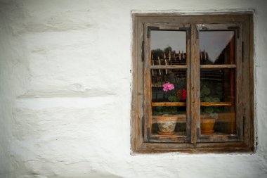 Vintage looking window of an old wooden house clipart