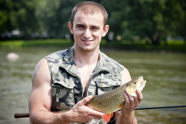 Happy angler with a big freshwater chub. — Stock Photo, Image