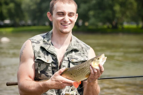 Happy angler with a big freshwater chub. — Stock Photo, Image