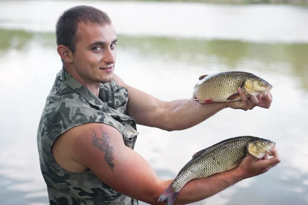 Happy angler with two freshwater chubs. — Stock Photo, Image