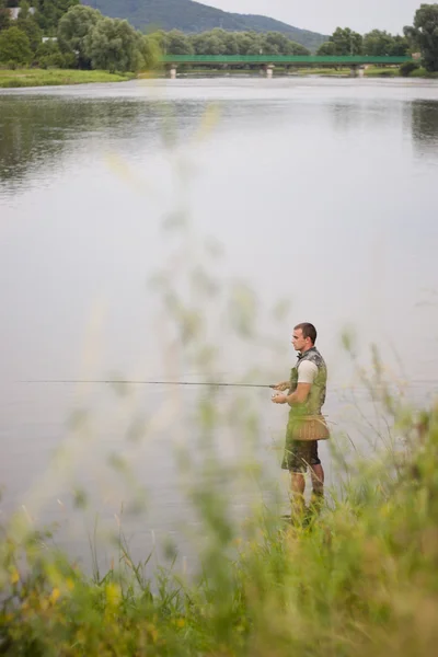Angler fishing for some freshwater chubs. — Stock Photo, Image