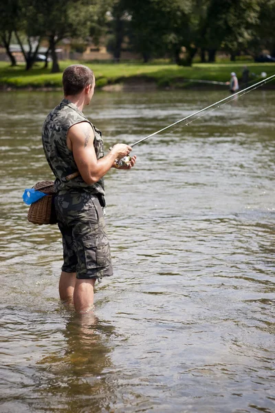 Angler fishing for some freshwater chubs. — Stock Photo, Image