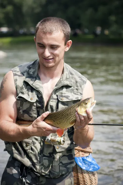 Happy angler with a big freshwater chub. Stock Photo