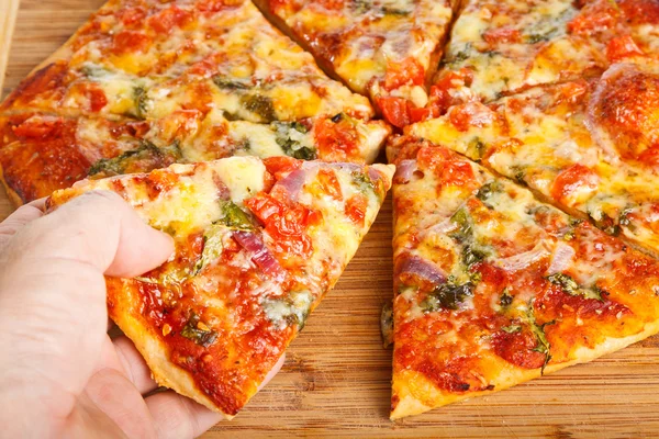 stock image Hand taking homemade pizza