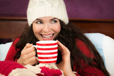 Beautiful woman having hot drink clipart