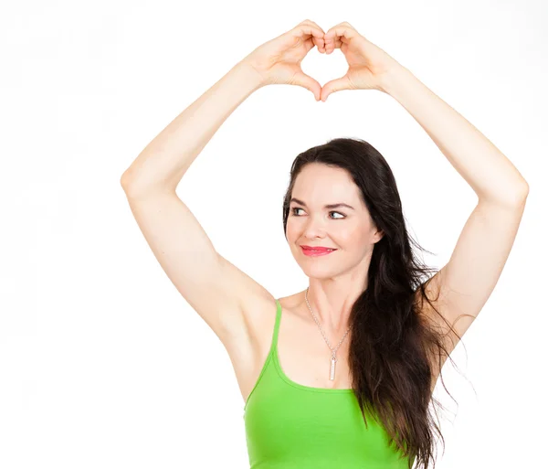 Beautiful woman forming love heart with hands — Stock Photo, Image