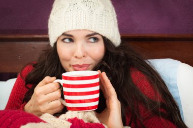 Beautiful woman having hot drink clipart