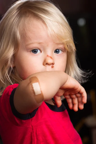 Injured boy with band aid on — Stock Photo, Image