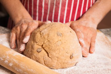 Hands kneeding a dough clipart