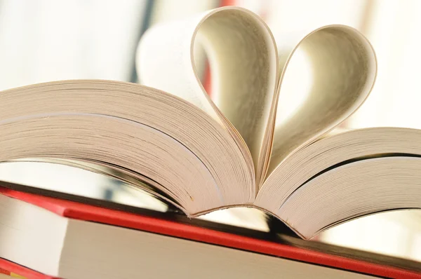 stock image Stack of books and pages formed in a shape of heart