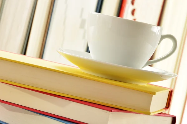Composition with stack of books and cup of coffee — Stock Photo, Image