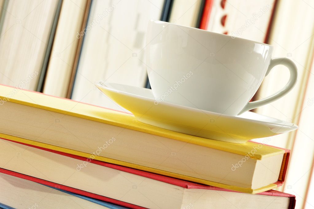 Composition with stack of books and cup of coffee