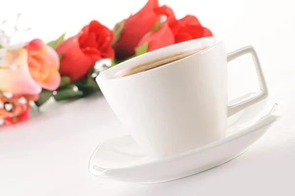 Stock image Composition with white cup of coffee and bouquet of roses