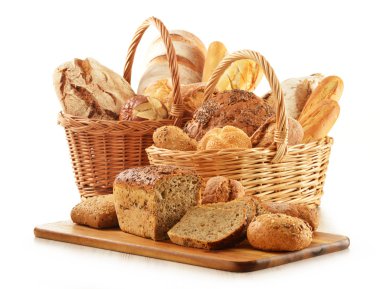 Bread and rolls in wicker basket isolated on white