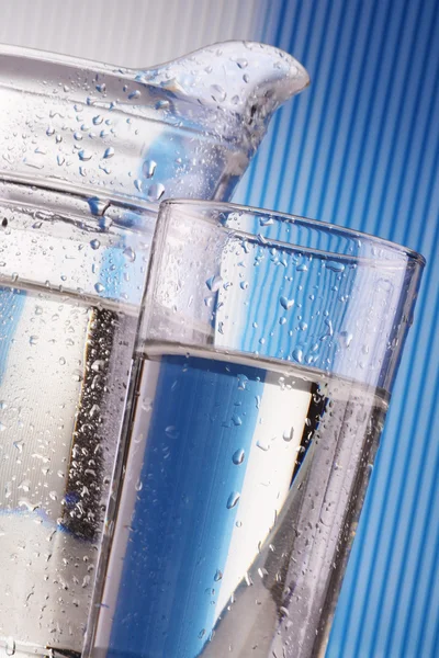 stock image Composition with glass of water on blue background