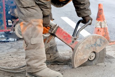 Upgrading road surfaces during repairing works clipart