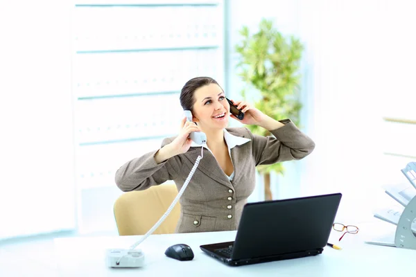 Portrait of happy business woman on phone call at office — Stock Photo, Image