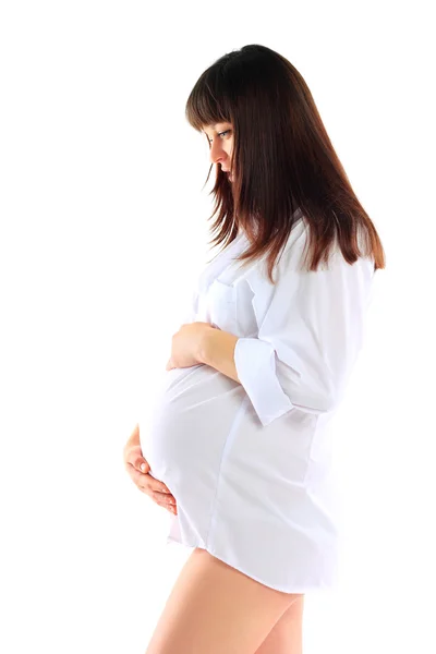 Pregnant woman caressing her belly over white background — Stock Photo, Image