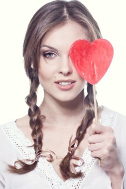 Lovely girl with a heart-shaped candy clipart