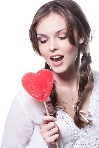 stock image Lovely girl with a heart-shaped candy